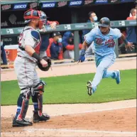  ?? Craig Lassig / Associated Press ?? The Twins’ Jorge Polanco, right, races home to scores the winning run on a single by Max Kepler as Red Sox catcher Christian Vazquez waits for the throw in the ninth inning on Thursday in Minneapoli­s.