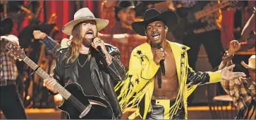  ?? Chris Pizzello Invision / Associated Press ?? LIL NAS X, right, and Billy Ray Cyrus perform “Old Town Road” at the BET Awards in June in Los Angeles.