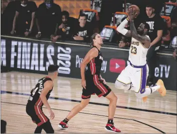  ?? ASSOCIATED PRESS ?? LOS ANGELES LAKERS’ LEBRON JAMES (23) takes a shot over Miami Heat’s Kelly Olynyk (9) during the second half in Game 6 of the NBA Finals on Sunday in Lake Buena Vista, Fla.