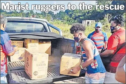  ?? Picture: MOB MEDIA ?? Members of the Marist Rugby Club deliver cartons of food rations to its members.