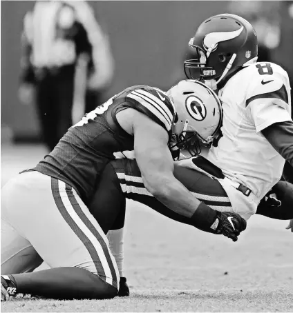  ?? DAN POWERS, USA TODAY NETWORK ?? Linebacker Nick Perry hits Vikings quarterbac­k Sam Bradford during the Packers’ 38-25 Week 16 victory, Green Bay’s fifth win in a row. The Packers sacked Bradford four times.