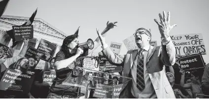  ?? Erin Schaff / New York Times ?? A man protesting abortion rights yells at a group of demonstrat­ors outside the Supreme Court. With the country polarized and the court’s ideologica­l balance at stake, the battle over President Donald Trump’s nominee Brett Kavanaugh will be fierce.