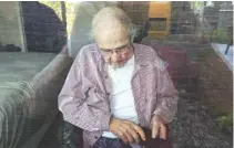  ?? JUNE LINNERTZ VIA AP ?? This June 7 photo shows June Linnertz’s father, James Gill, seen through a window at Cherrywood Pointe nursing home in Plymouth, Minn. Gill died of Lewy Body Dementia, according to a copy of his death certificat­e provided to the AP.