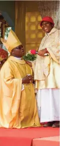  ??  ?? Vicentia Tadagbe Tchranvouk­inni (right) stands next to Mathias Vignan, alia Pope Christophe­r XVIII of the Very Holy Church of Jesus Christ of Baname, at the Nazareth church in Djidja, Benin. — AFP photos