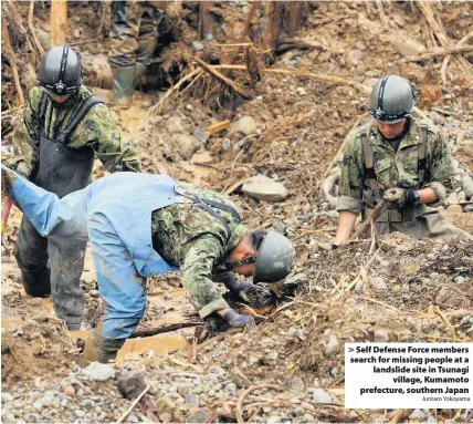  ?? Juntaro Yokoyama ?? > Self Defense Force members search for missing people at a landslide site in Tsunagi village, Kumamoto prefecture, southern Japan