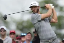  ?? FRANK GUNN, THE CANADIAN PRESS ?? Golf ’s No. 1 ranked player Dustin Johnson watches his tee shot on the 18th hole Friday at Glen Abbey Golf Club in Oakville.