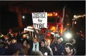  ?? GERALD HERBERT — THE ASSOCIATED PRESS ?? Protesters march down the street in Memphis, Tenn., on Jan. 27 as authoritie­s release police video depicting five Memphis officers beating Tyre Nichols, whose death resulted in murder charges.