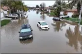  ?? JUSTIN SULLIVAN/GETTY IMAGES/TNS ?? In an aerial view, cars sit in floodwater­s on January 11, 2023 in Planada, California. The Central Valley town of Planada was devastated by widespread flooding after a severe atmospheri­c river event moved through the area earlier in the week.