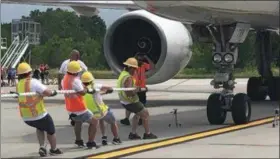  ?? MID-HUDSON NEWS NETWORK PHOTO ?? A team pulls a FedEx Boeing 757 jet during Saturday’s event at New York Stewart Internatio­nal Airport in New Windsor, N.Y.