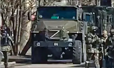  ?? ?? OCCUPIERS: Russian troops and armoured vehicles in the streets of the southern Ukraine city of Kherson