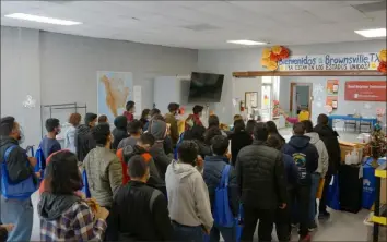  ?? Giovanna Dell'Orto/Associated Press ?? People line up inside the migrant welcome center across from the bus station Friday in Brownsvill­e, Texas.