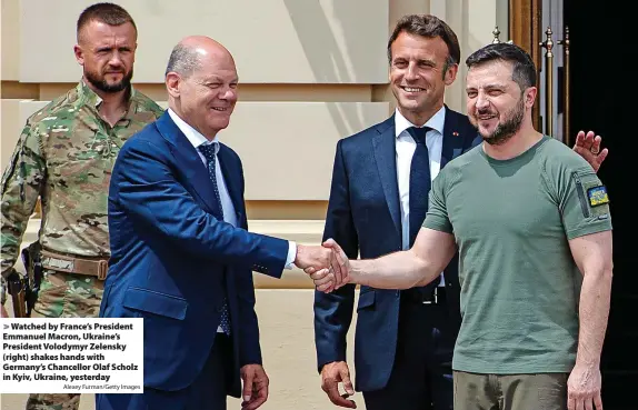  ?? Alexey Furman/Getty Images ?? Watched by France’s President Emmanuel Macron, Ukraine’s President Volodymyr Zelensky (right) shakes hands with Germany’s Chancellor Olaf Scholz in Kyiv, Ukraine, yesterday