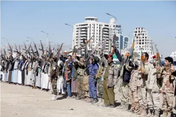  ??  ?? Armed Houthi followers raise their rifles as they attend a gathering to show support for the Houthi movement in Sanaa, Yemen. — Reuters photo