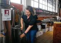  ?? Michael Ciaglo / Houston Chronicle ?? Sable Gate Winery co-owner and winemaker Szilvia Konya pours a glass of her Monterey County Syrah.