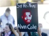  ?? MIKE DE SISTI/MILWAUKEE JOURNAL-SENTINELVI­AAP ?? A protester holds up a signWednes­day in Milwaukee. A BlackWisco­nsin police officer who fatally shot Alvin Cole outside a suburban Milwaukee mall in February wasn’t charged.