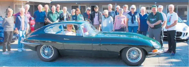  ?? ?? Members of the Wellington Jaguar Drivers Club cluster around Murray Mason in his 1962 E-Type Jaguar at Destinatio­ns Motor Lodge on Saturday, May 7.