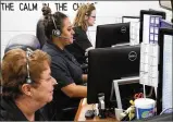  ?? BILL LACKEY/ STAFF ?? Three of the dispatcher­s in the Clark County Dispatch Center answer emergency calls in 2017.