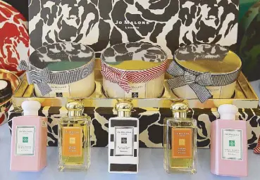  ??  ?? The scents of Christmas: Jo Malone’s limited-edition holiday colognes (from left) Green Almond & Redcurrant, Orange Bitters, English Pear & Freesia and Deluxe Candle collection (in box) are available at Jo Malone boutiques and popups.