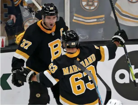  ?? Stuart CaHill / Herald staff file ?? HAPPY FOR EACH OTHER: Bruins center Patrice Bergeron celebrates his goal with left wing Brad Marchand during a Nov. 26 game against the Rangers.