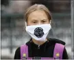  ?? FREDRIK SANDBERG / TT VIA AP ?? Swedish climate activist Greta Thunberg wears a face mask declaring “Fridays for Earth’s Future” as she protests in front of the Swedish Parliament Riksdagen, in Stockholm on Friday.