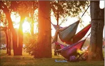  ?? DEBORAH CANNON / AMERICAN-STATESMAN ?? Georgia Irons (bottom), 13, relaxes in a hammock June 20 at Zilker Park. Austin wouldn’t have Zilker or other parks if landowners hadn’t worked to preserve them, a reader writes.