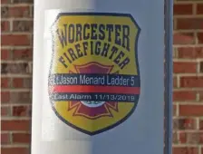  ?? CHRIS CHRISTO / HERALD STAFF ?? HONORING A FALLEN HERO: A posting at the McKeon Road fire station in Worcester honors Lt. Jason Menard.