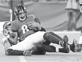  ?? GEOFF BURKE/USA TODAY SPORTS ?? Ravens quarterbac­k Lamar Jackson is sacked Jan. 11 by Titans outside linebacker Kamalei Correa.