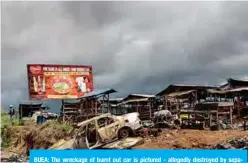  ??  ?? BUEA: The wreckage of burnt out car is pictured - allegedly destroyed by separatist­s fighter in a recent attack, as a Cameroonia­n soldier patrols the edge of the abandoned market in the majority anglophone South West province in Buea. —AFP