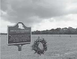  ?? [AP PHOTOS] ?? This March 28 photo shows the Bruslie Cemetery, a burial ground for slaves in New Orleans. The Shell Oil Co. has spruced up, marked and blocked off tracts of its land in the Convent community west of New Orleans where archaeolog­ists confirmed the...