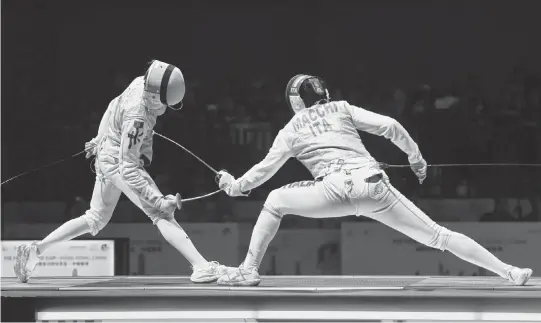  ?? LO PING FAI USA TODAY NETWORK ?? Leung Chin Yu, left, of China’s Hong Kong competes against Macchi Tilippo of Italy during the men’s senior foil team final at the 2024 FIE Foil World Cup in Hong Kong on May 4, 2024.