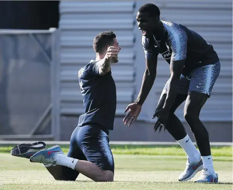  ?? GETTY IMAGES ?? France defender Lucas Hernandez, left, jokes with midfielder Paul Pogba during training on Thursday ahead of their 2018 World Cup final match against Croatia. Pogba has looked better with each outing for a young France squad that’s been amazingly consistent.