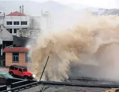  ??  ?? FROM SEA TO RAGING SEA: A huge wave breaks over a vehicle at the shore ahead of the landfall of Typhoon Chan-Hom in Wenling in eastern China’s Zhejiang province on Friday.