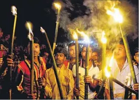  ?? HT FILE/ SUBHENDU GHOSH ?? Enclave dwellers with torches celebrate the historic India-Bangladesh land swap deal at Madhya Mashaldang­a in West Bengal’s Cooch Behar in August this year.