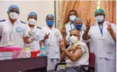  ?? — PTI ?? Dr Vijay Yewale, a pediatrici­an, shows a victory sign along with medics after receiving the dose of Covid19 vaccine at NMMC Hospital in Navi Mumbai.