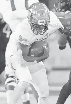  ?? SUE OGROCKI/ AP ?? USF’s Jordan Cronkrite, left, fights off a tackle by Tulsa safety Manny Bunch during the 2018 season. Cronkrite, a Florida transfer, is one of the Bulls’ top returning playmakers.