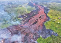  ?? U.S. GEOLOGICAL SURVEY VIA AP ?? Lava flows from fissures Saturday near Pahoa, Hawaii. Kilauea volcano has burned dozens of homes, forced people to flee and shot up plumes of steam that led officials to distribute face masks to protect against ash particles.