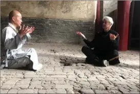  ??  ?? Brahm practices with Shi Deyang, a kung fu master at Shaolin Temple in Henan province.