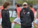  ?? KYLE FRANKO — TRENTONIAN PHOTO ?? Rider head coach Charlie Inverso, right, talks with assistant Mark Practico, left, prior to a MAAC semifinals game against Monmouth this spring. Inverso is one of the inaugural inductees into the Mercer County Community College Hall of Fame.