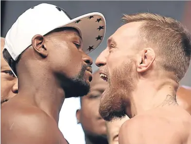  ?? Picture: Getty. ?? Floyd Mayweather, left, and Conor McGregor at yesterday’s official weigh-in.