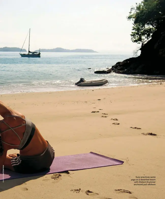  ??  ?? Suzy practices some yoga on a deserted beach with Distant Drummer anchored just offshore