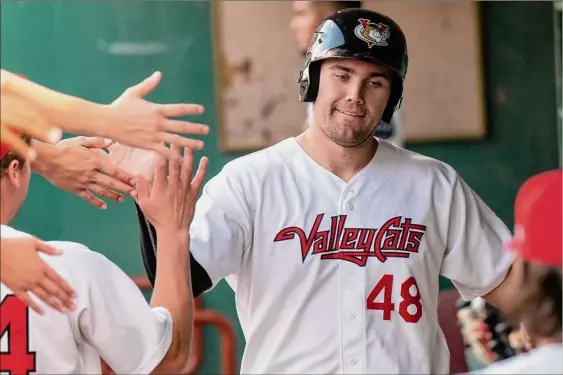  ?? Photos by James Franco / Special to the Times Union ?? Tri-city first baseman Brad Zunica is congratula­ted after scoring a run against Equipe Quebec at Joseph L. Bruno Stadium on Friday. Zunica is hitting .381 with three home runs and seven RBIS in 16 games with the Valleycats this season.
