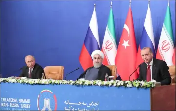  ??  ?? A handout picture released by the office of Rouhani (centre) shows him giving a press conference with Erodgan (right) and Putin in Tehran after their trilateral meeting as Iran hosted a summit on the Syrian conflict. — AFP photo