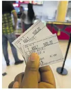  ?? ?? An adult patron holds tickets purchased to see a crowd favourite film, John Wick, at the Caribs cinema recently.