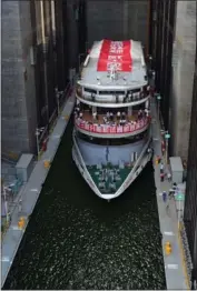  ?? XINHUA ?? The trial operation of a permanent shiplift at the Three Gorges Dam in Central China’s Hubei province has started. The vertical-hoisting elevator helps small and medium-sized ships to traverse the dam. The water level behind the dam is up to 370 feet...