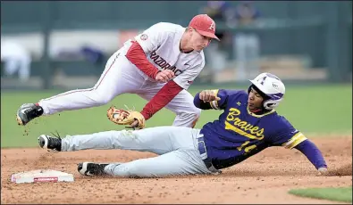  ?? NWA Democrat-Gazette/ANDY SHUPE ?? Arkansas shortstop Jax Biggers, shown tagging out a base runner against Alcorn State on March 14, signed with the Razorbacks after helping lead Cisco (Texas) Junior College to the National Junior College World Series last season.