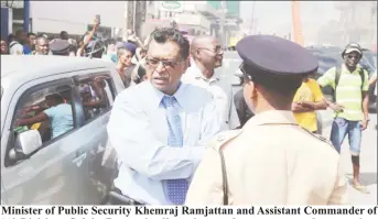  ?? (Photo by Keno George) ?? Minister of Public Security Khemraj Ramjattan and Assistant Commander of ‘A’ Division, Calvin Brutus in discussion at the scene yesterday morning.