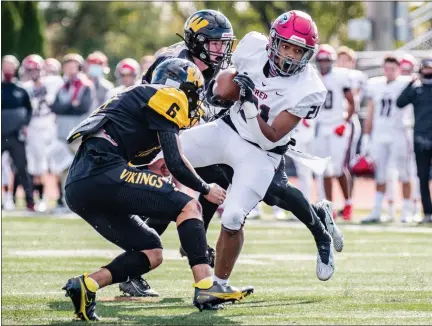  ?? JAMES BEAVER/FOR MEDIANEWS GROUP ?? St. Joseph Prep’s Noble House (21) breaks through the Archbishop Wood line during a rush up the middle in a game on Saturday.