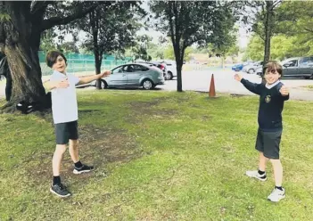  ??  ?? St Botolph’s Year Six leavers Cole and Tom offer an ‘air hug’ farewell.