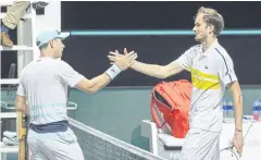  ?? AFP ?? Daniil Medvedev, right, and Dusan Lajovic shake hands at the end of their first round match on Wednesday.