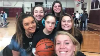  ?? SUBMITTED PHOTO ?? Charlotte Goldkamp, center (wearing headphones) took part in Garnet Valley’s “Best Buddy Day” program with, clockwise from left, GV girls basketball players Annie Bechthold, Jillian Nagy, Gianna Preising, Taylor Daubenberg­er, and Kendall DiCamillo.